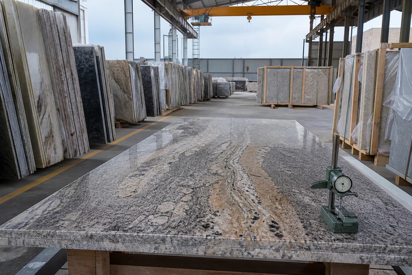 Natural stone slabs and inspection equipment in an export yard.